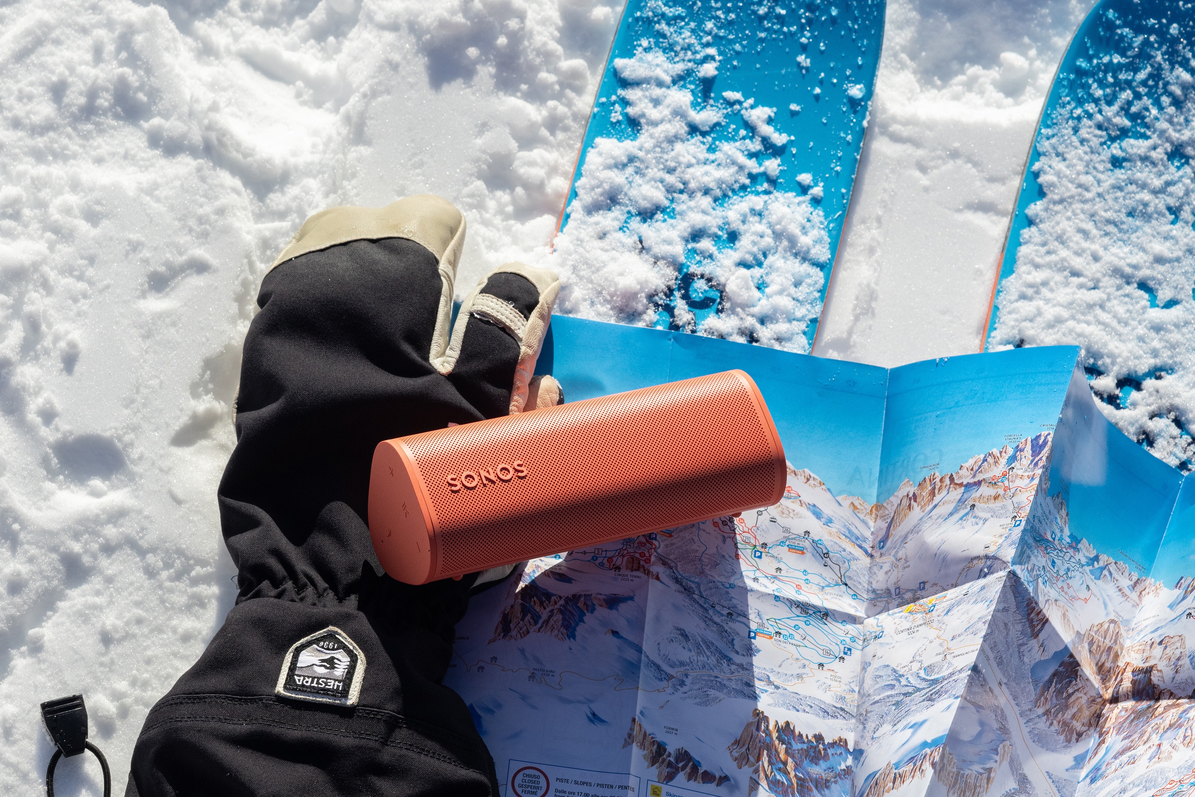 Roam 2 Sunset on a glove and skis in the snow