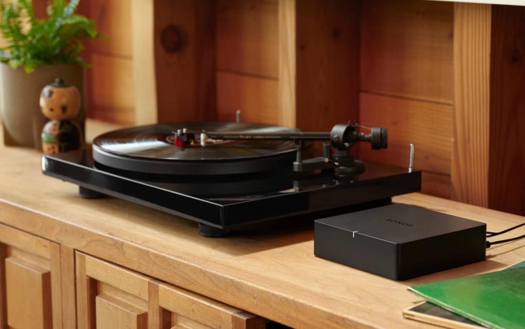 Sonos Port on a shelf next to a traditional stereo receiver