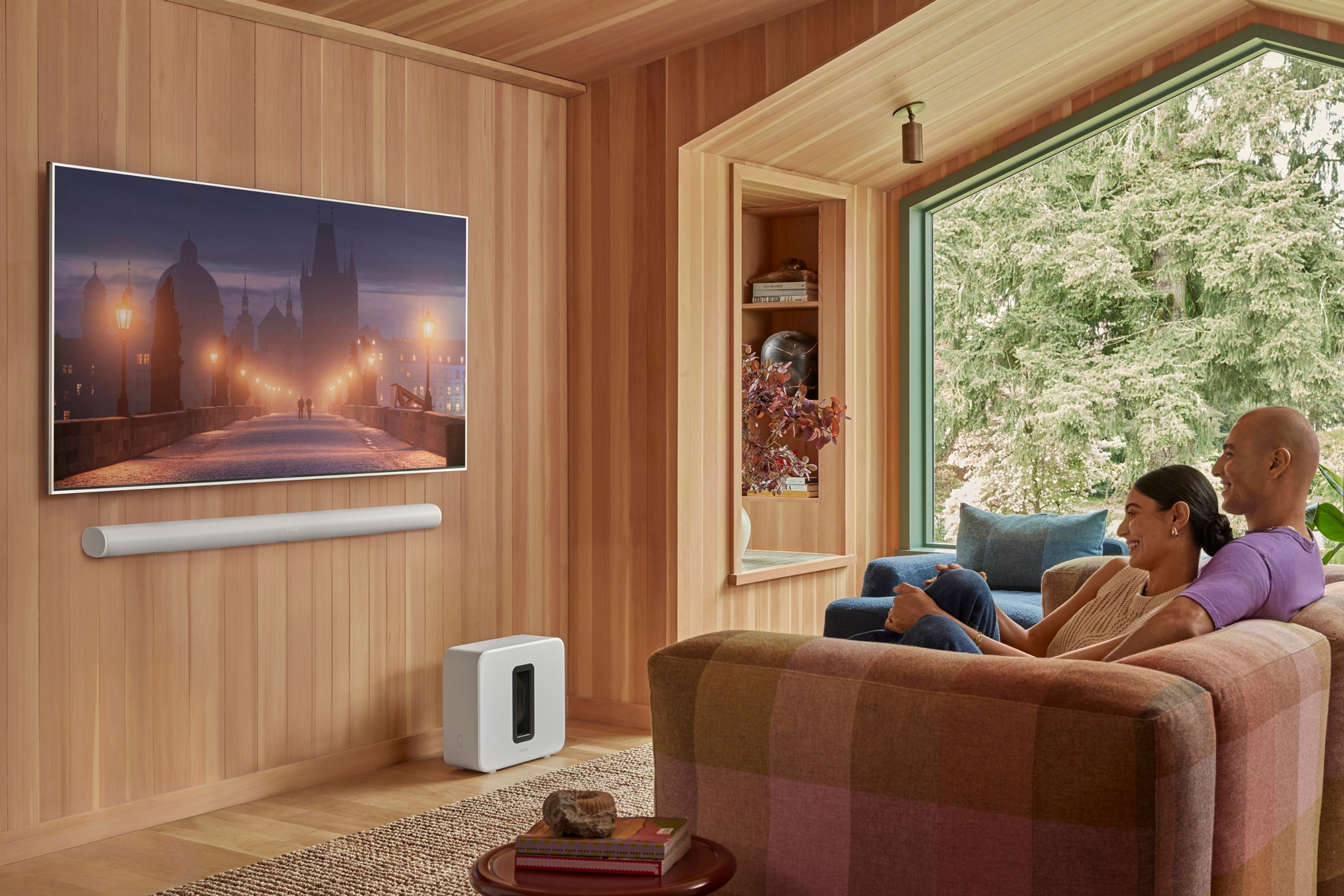 Couple watching TV on Arc Ultra with Sub 4 in the living room