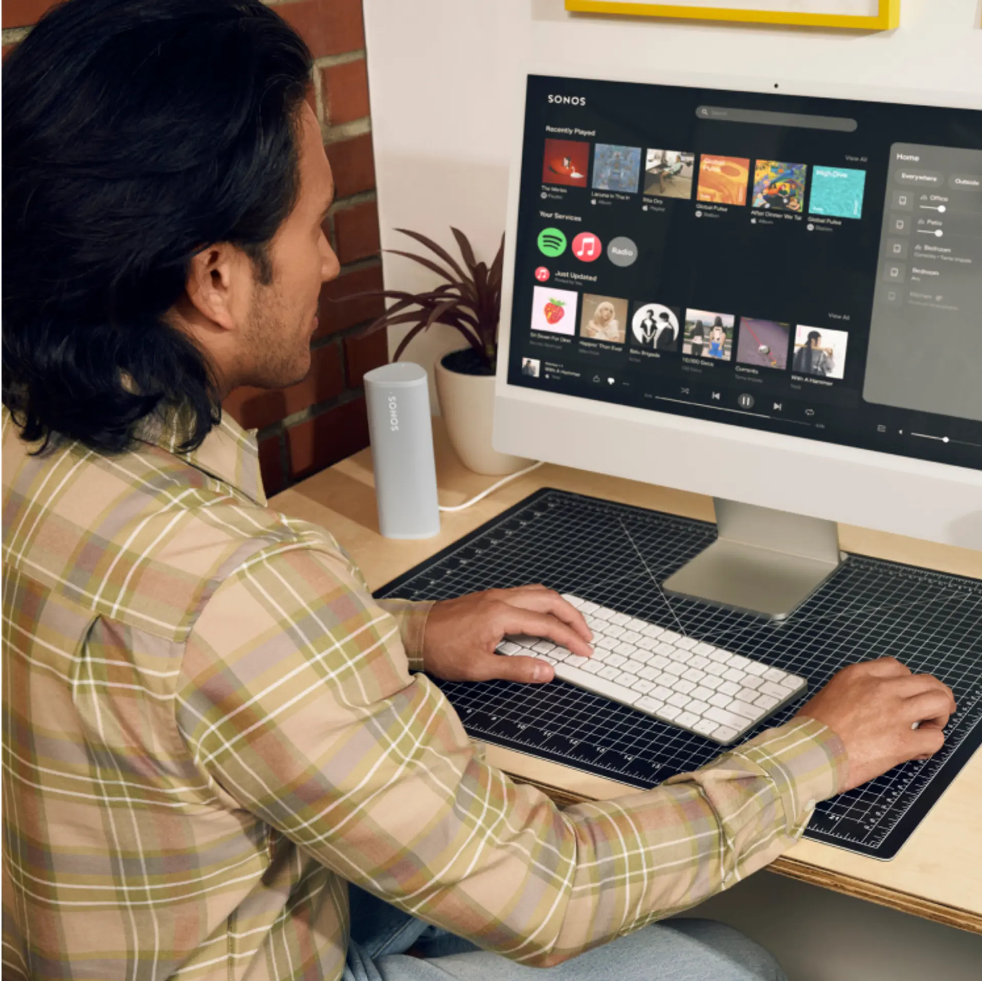 A computer with the Sonos Web app open in a web browser