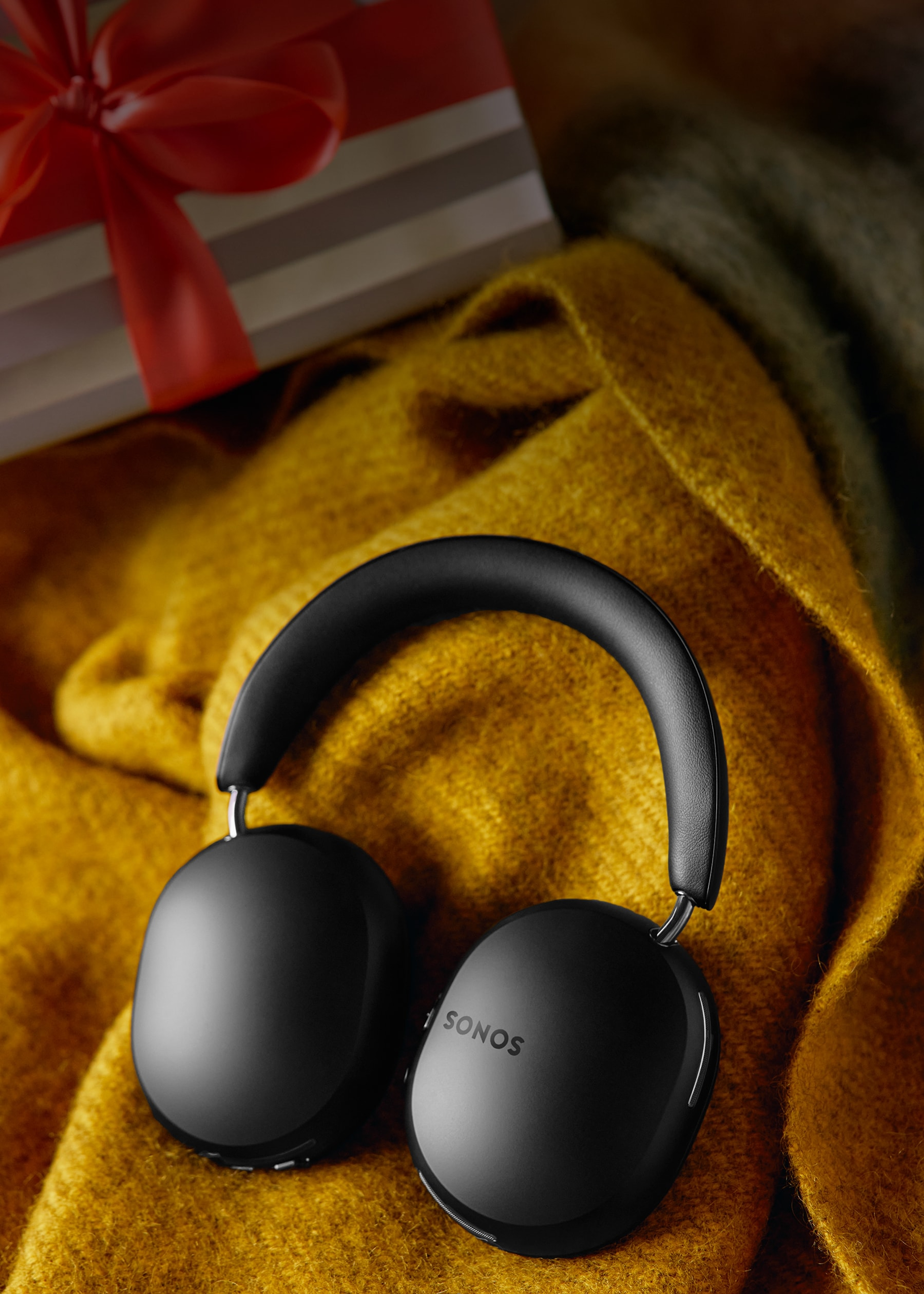 Black Sonos Ace headphones on a blanket
