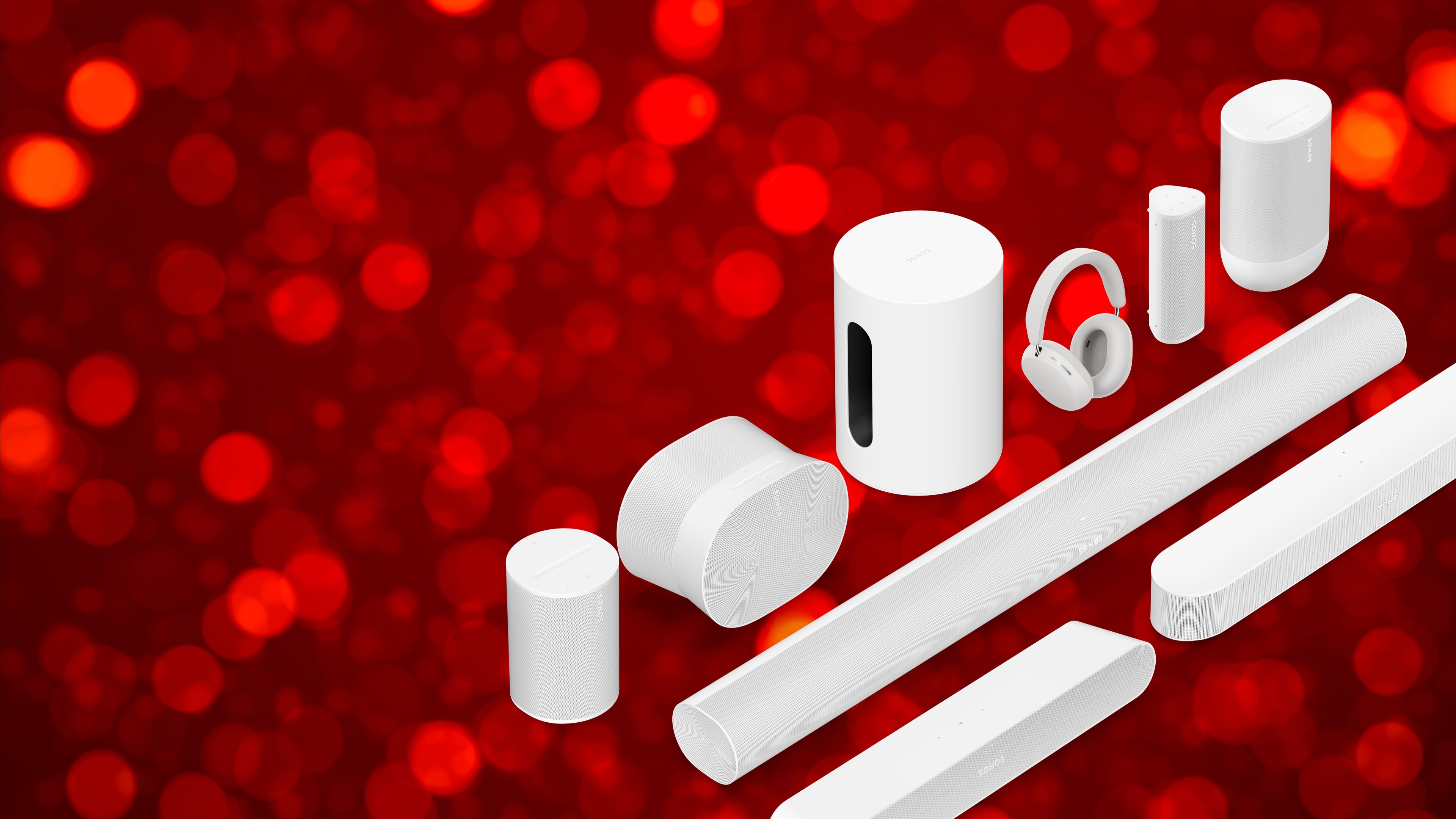 Lineup of white Sonos products over a twinkling red background