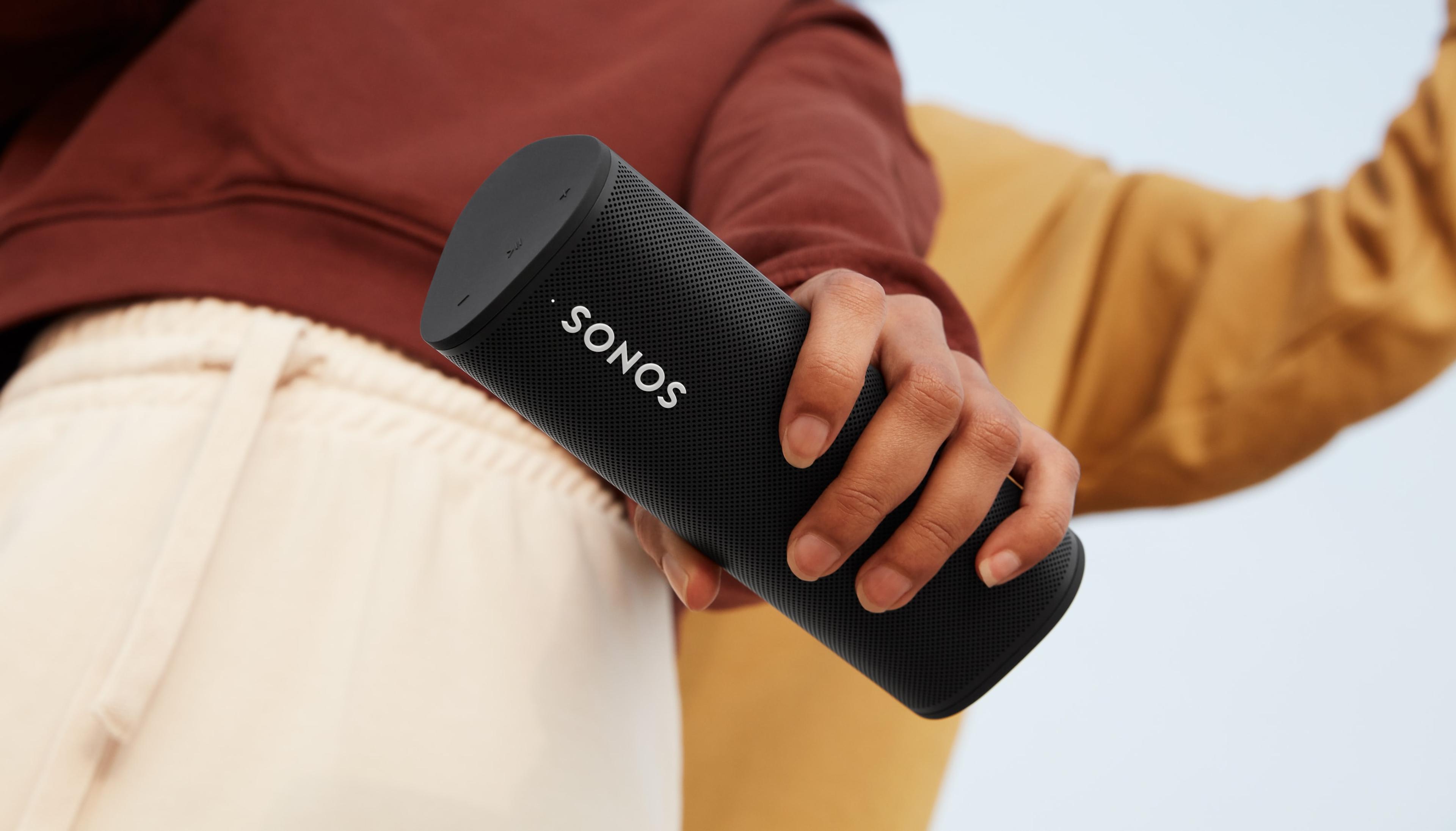 Closeup of woman holding a black Roam SL outside