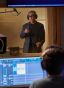 Giancarlo Esposito speaking with an audio engineer in the studio