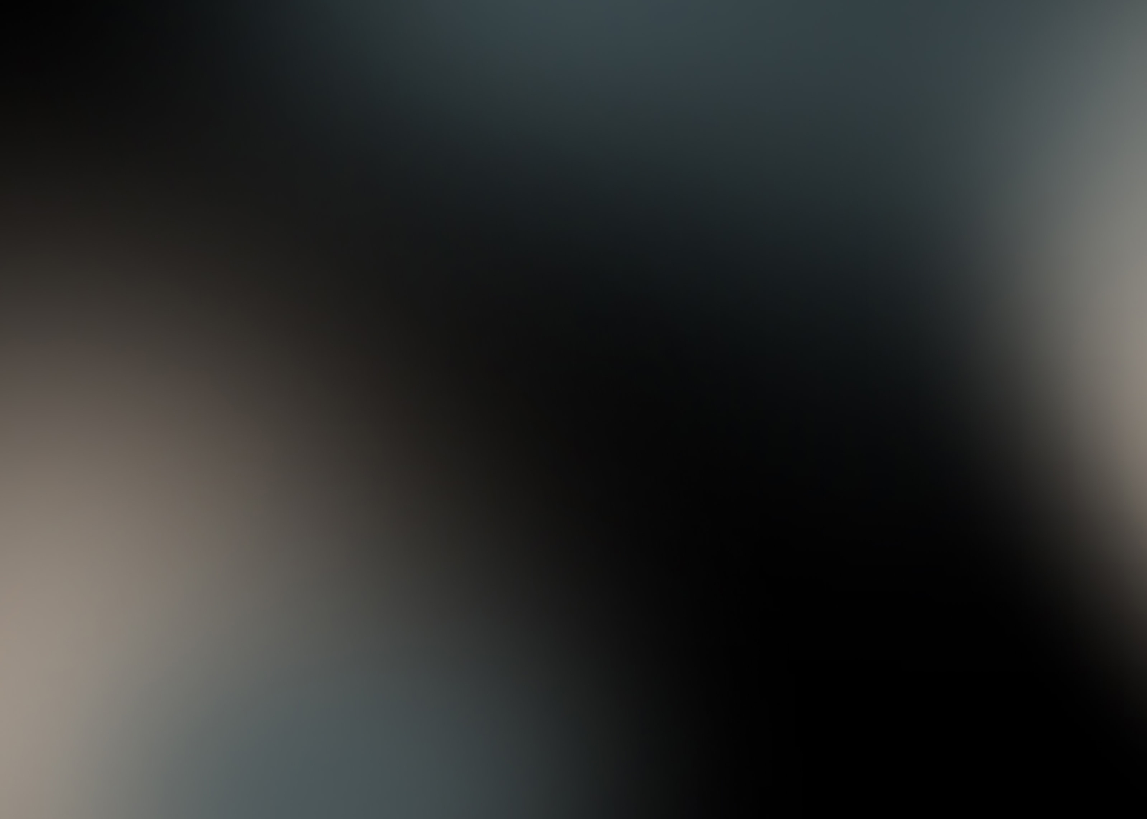 Tan and grey color gradients over a black background