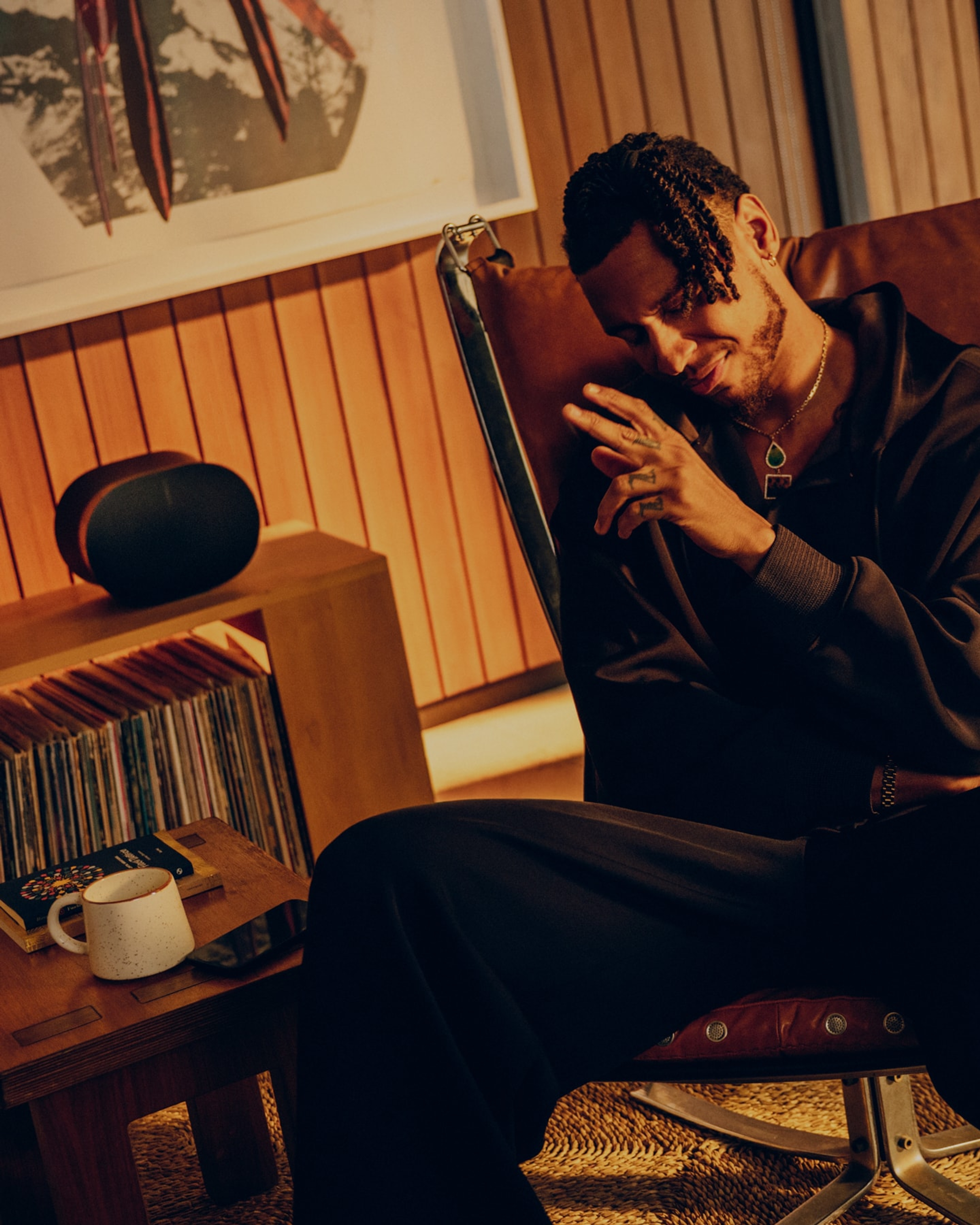 Musician and singer Masego listening to vinyl in his living room on a black Sonos Era 300 speaker