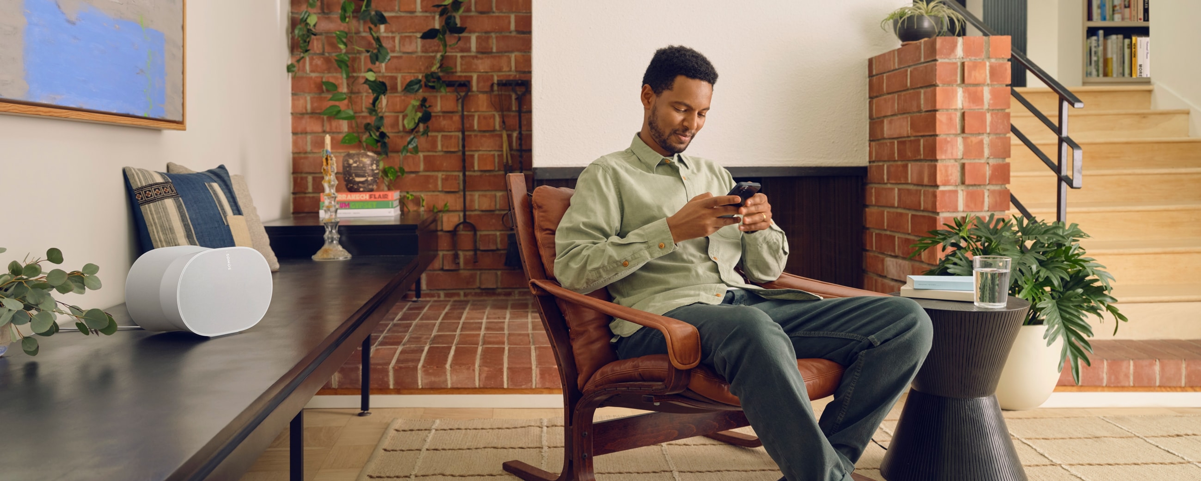 Person using their phone to control Sonos Era 300