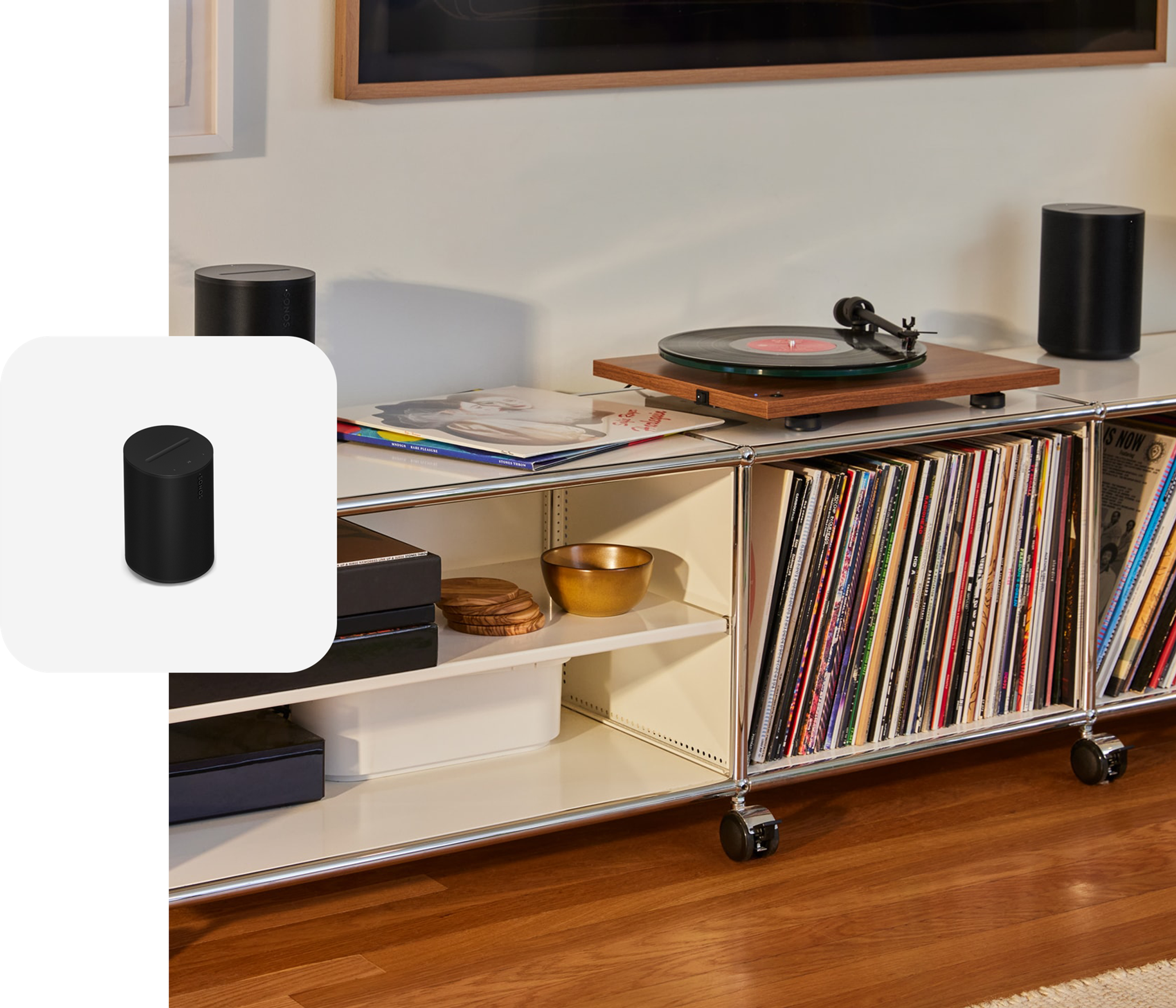 A pair of black Sonos Era 100 SL speakers on a record console connected to a turntable