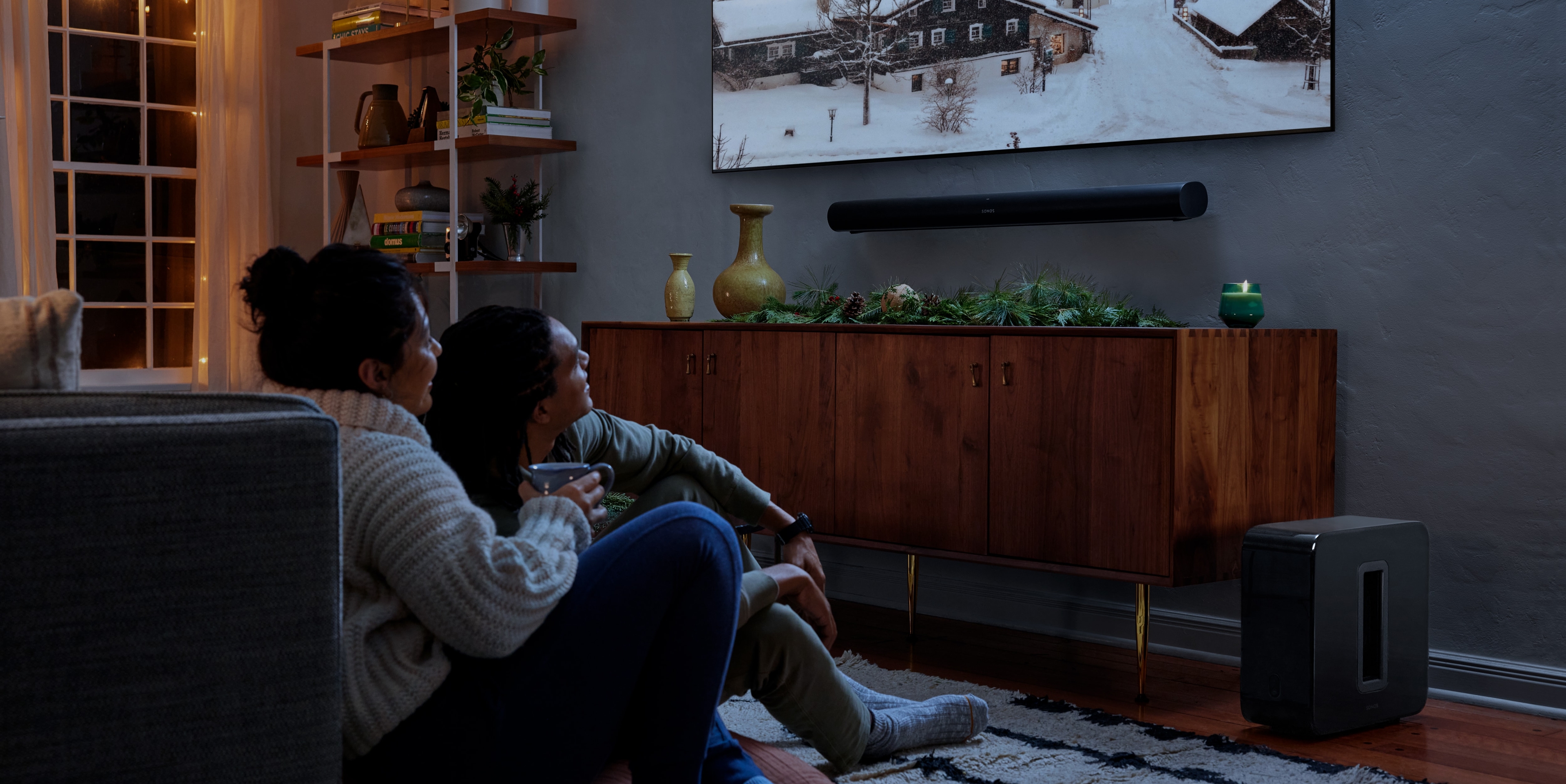 Couple watching a movie with Sonos Arc and Sub